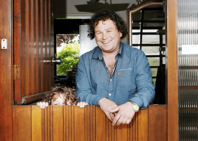 Man en kind staan bij de voordeur